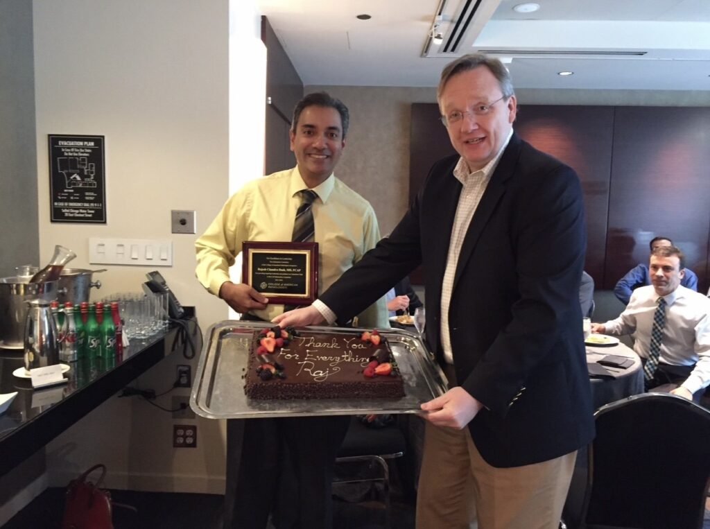 Receiving an award for excellence in leadership from Wally Henricks